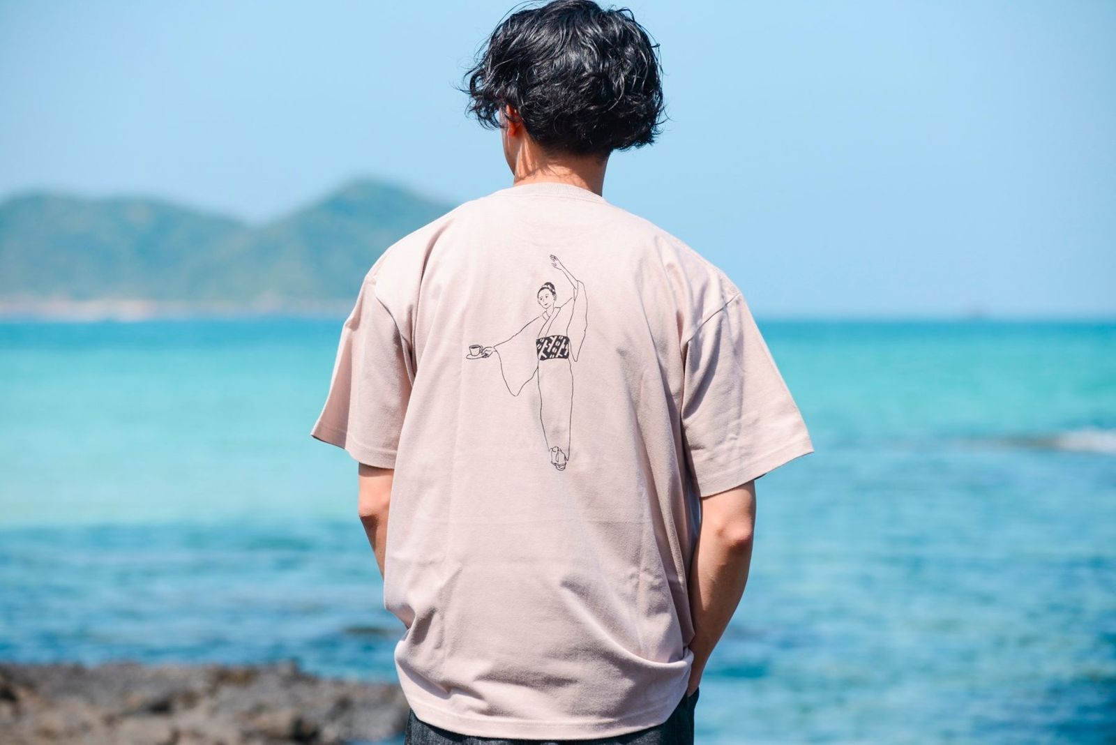 背中に踊り子が描かれたスモーキーピンクのTシャツ
